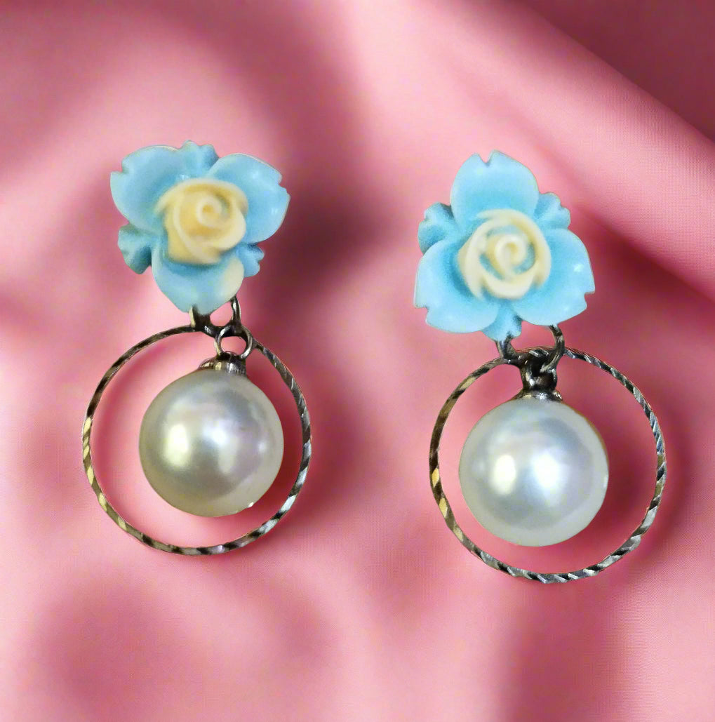 Trendy statement earrings with bold geometric design, fashion-forward jewelry for women. Punnagaidj. Black metal. Classic pearl earrings with black metal setting.must-have jewelry for an elegant look