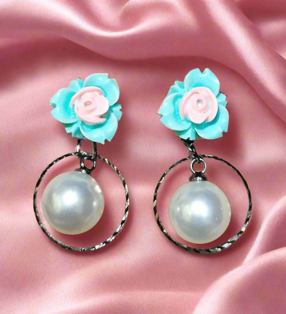 Trendy statement earrings with bold geometric design, fashion-forward jewelry for women. Punnagaidj. Black metal. Classic pearl earrings with black metal setting.must-have jewelry for an elegant look