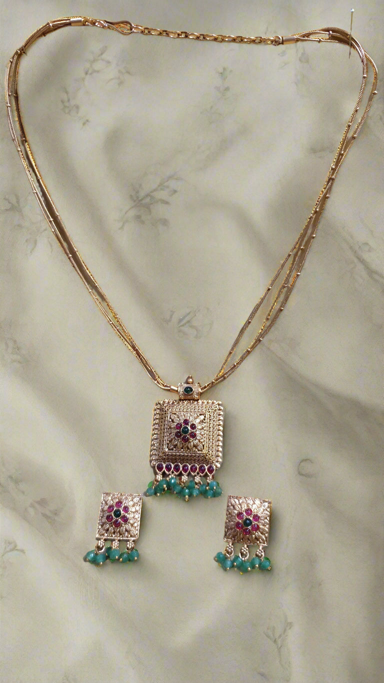 3 layered Gold Chain with pendent and ruby and Emerlad with beads